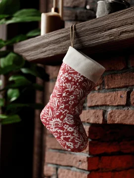 Christmas stocking mockup hanging on rustic fireplace interior