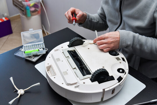 Master repairs the robot vacuum cleaner.