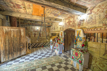 Maramures, Romania - Aug 13, 2025: Interior of the 18th-century Saint Parascheva wooden church in Desesti, Maramures, Romania, displaying traditional frescoes and religious icons