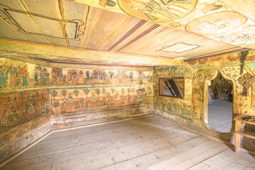 Maramures, Rogoz, Romania - Aug 13, 2025: Rogoz Holy Archangels Church interior showing intricate religious frescoes on the wooden ceiling and balcony, representing historical Orthodox art