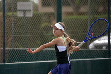 tennis player with a racket doing drills on a tennis court  