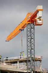 construction site with crane lifting load 