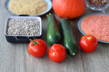 Assortment of various healthy fruits, vegetables, grains and legumes. Selective focus, wooden background.