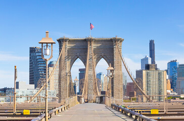 The pedestrian section of the Brooklyn Bridge in New York City is empty of people during the day.