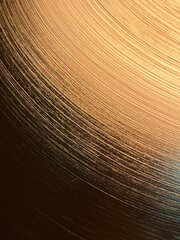 Obraz premium Curved line pattern on a golden colored surface with light and shadow, abstract artistic background