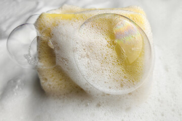 A refreshing cleanliness concept with yellow soap and bubbles in the lather