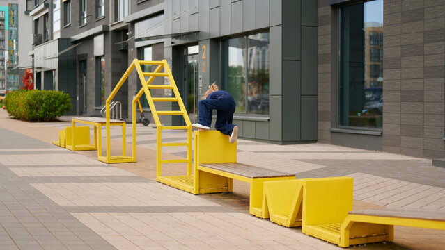 urban playground with climber on vibrant yellow structures offers modern outdoor exercise space in city setting. bright design enhances workout experience and encourages creativity
