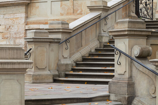 old school urban cathedral architectural patterns of ancient marble stairs and handrails historical building entrance shapes close up