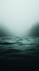 Fototapeta premium Misty waters ripple under a blanket of fog, obscuring the distant shore. The scene exudes a sense of mystery and tranquility, inviting contemplation. Moody atmosphere.