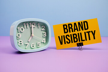 Brand Visibility text and alarm clock on blue and purple background