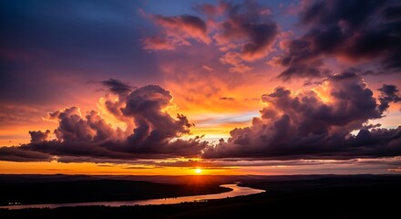 Dramatic sunset with colorful clouds over a winding river landscape view