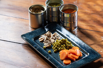 Servings of canned vegetables on a plate as a concept for National Canned Food Day.