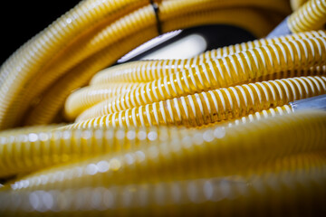 Repetitive pattern of yellow coiled pipes symbolizing flexibility, energy flow and connectivity in...
