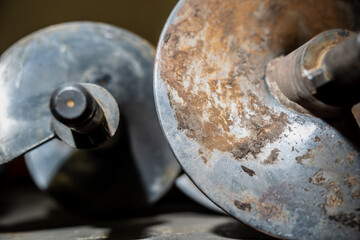 Rusty metal auger blades and drilling equipment parts representing heavy construction machinery, industrial maintenance, soil excavation tools and mechanical components