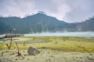view of white crater with sulfuric gas in java in indonesia