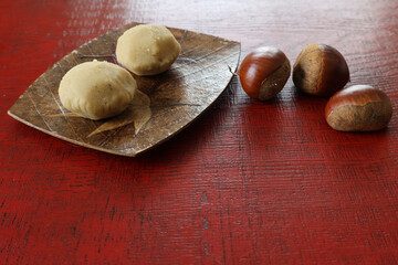 漆塗り板に置かれた皿にのせた栗きんとん