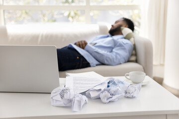 Tired man takes break after intense work on laptop