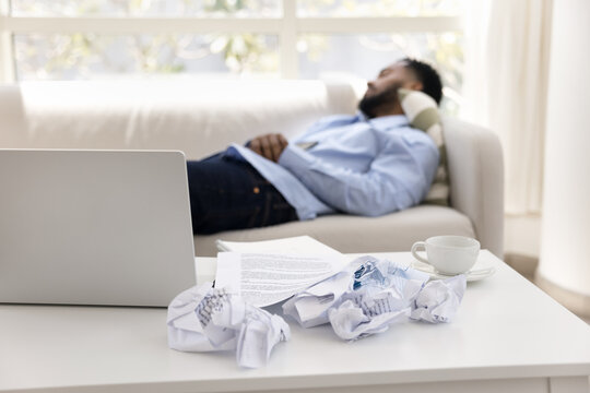 Tired man takes break after intense work on laptop