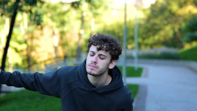 Young Caucasian man feeling pain after working out. Sportsman running in park