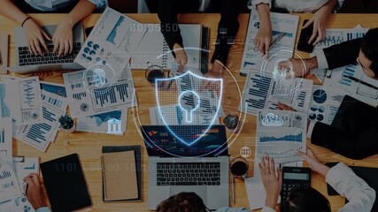 A diverse business team collaborates on innovative digital security strategies, surrounded by charts and graphs, in a modern office space, enhancing data protection. Raster - Powered by Adobe