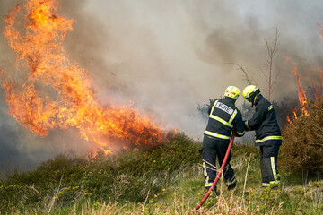 Wildfires fire burning with a lot of smoke, firefighters