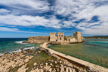 Fototapeta premium Greece, Peloponnese, Methoni - 4 April 2024 - The imposing fortress of Methoni is immersed in the crystal clear waters of the Mediterranean Sea