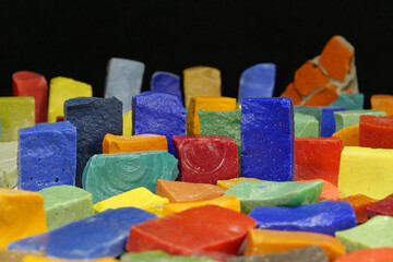 Multi-colored smalt from Soviet mosaics on black background