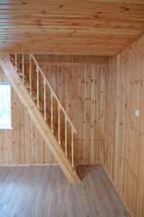 A new wooden staircase leading to the second floor of the house