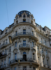 An ornate building with balconies and a domed top.