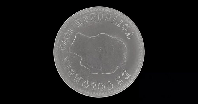 Obverse of Colombia coin 20 centavos 1970, isolated in black background. Loopable animation in 4k resolution video