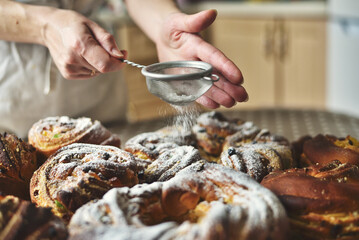 Hand Dusting Easter Cakes with Powder