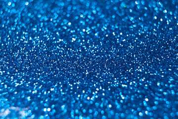Blue glitter texture christmas abstract background. Defocused lights bokeh.