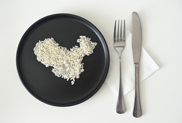 Uncooked white rice grains arranged into a map of China, presented on a minimalist black plate