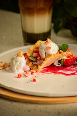 Crispy waffle bowl filled with scoops of ice cream and fresh fruits, styled as a gourmet dessert. A colorful and appetizing image that highlights freshness, sweetness, and the visual pleasure of an ar