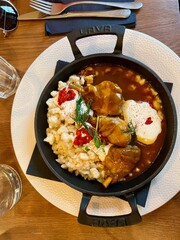 Hungarian goulash stew with nokedli dumplings and sour cream