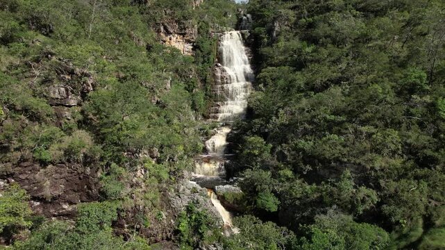 panoramic aerial view of waterfalls in Chapada dos Veadeiros, Vale do Macaco, large river with incredible large waterfalls, sunny day, trees, crystal clear water, Brazilian landscape