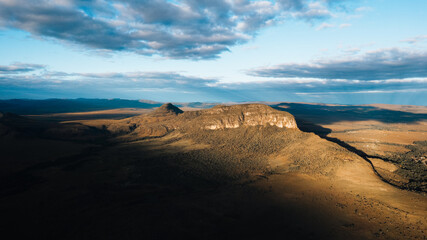 Morro da Baleia aerial view, Chapada dos Veadeiros, mountains, green fields with buritis, Jardim de Maytrea, Alto Paraiso de Goias at golden hour sunset
