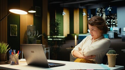 Discouraged woman creating plans and documenting objectives to share with executives during next morning meeting. Employee drained and in a mental haze doing overtime, pushing limits. Camera A.