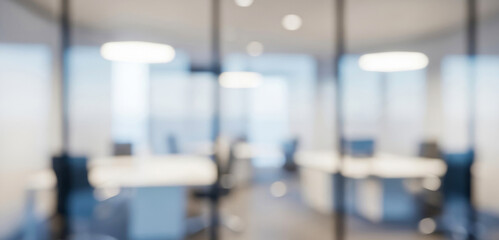 Blurred modern office interior with glass partitions and bright lights, capturing a contemporary corporate atmosphere filled with elegant reflections and a dynamic professional mood.