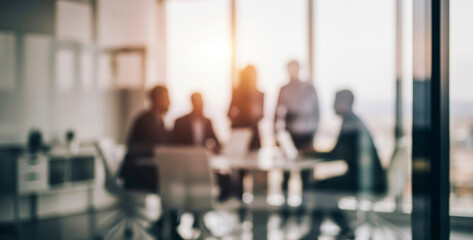 Blurred business meeting with silhouetted figures around a table indoors, showing teamwork, collaboration, and leadership within a dynamic professional environment under soft lighting.