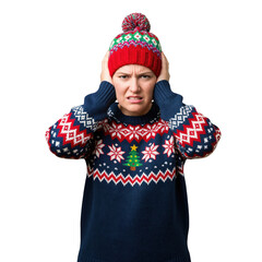 Distressed young woman in a festive ugly Christmas sweater and winter bobble hat covering her ears, expressing discomfort or annoyance against a transparent background.