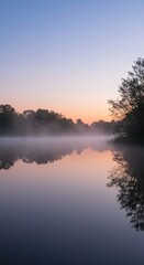 Extremely still pond water reflecting the soft colors of the early morning sky. A perfect surface showing peace and tranquility ,repose ,abstract ,lake