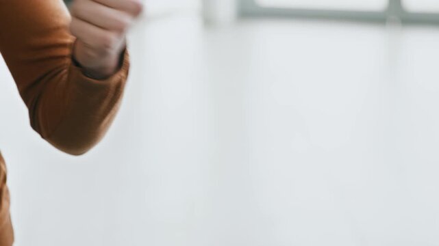 A young adult receives car keys from a salesperson at a busy auto salon. The focus is on the transaction, showcasing leasing options in an inviting environment.
