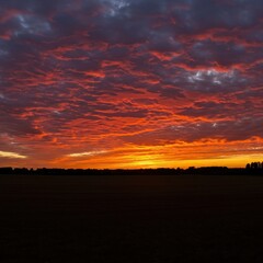 Obraz premium Expansive wide-angle panorama capturing the breathtaking beauty of the evening sky at dusk with fiery celestial hues ,fiery ,beautiful ,horizon