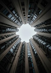 Fototapeta premium Looking straight up at a dizzying array of modern, smooth architectural facades and vertical lines, creating a sense of massive scale and height ,pattern ,lines ,imposing