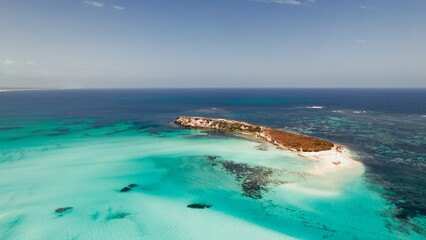 Turquoise waters and a serene island landscape during a clear sunny day