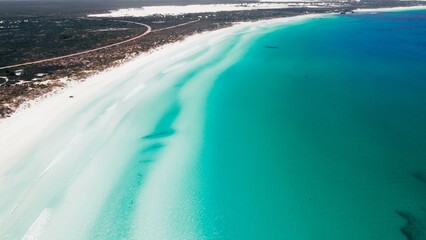 Beautiful turquoise waters meet sandy shores in a tranquil coastal scene