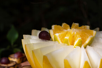An artistically cut melon and orange