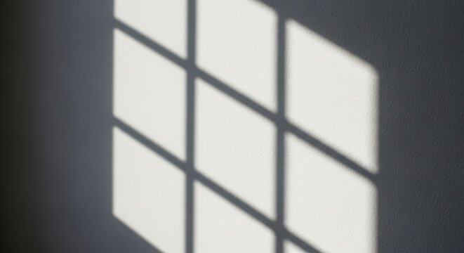 Geometric shadow pattern cast by a window pane on a plain surface isolated on white background