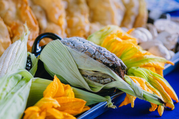 Close-up of fresh huitlacoche (corn smut) and squash blossoms, typical and exotic ingredients of traditional Mexican cuisine.